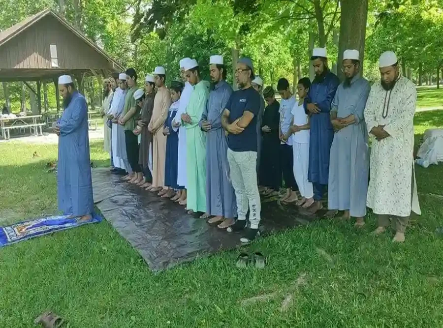RAF community members praying together outdoors